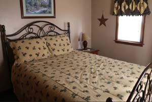 bedroom, tan walls, wood bedframe